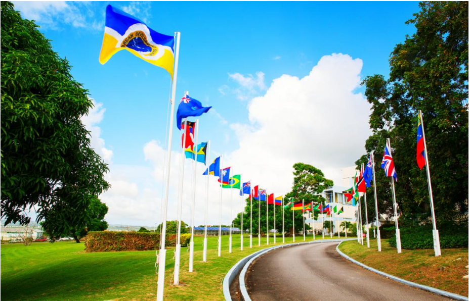 CDB curved driveway with flags hoisted against a clear blue sky