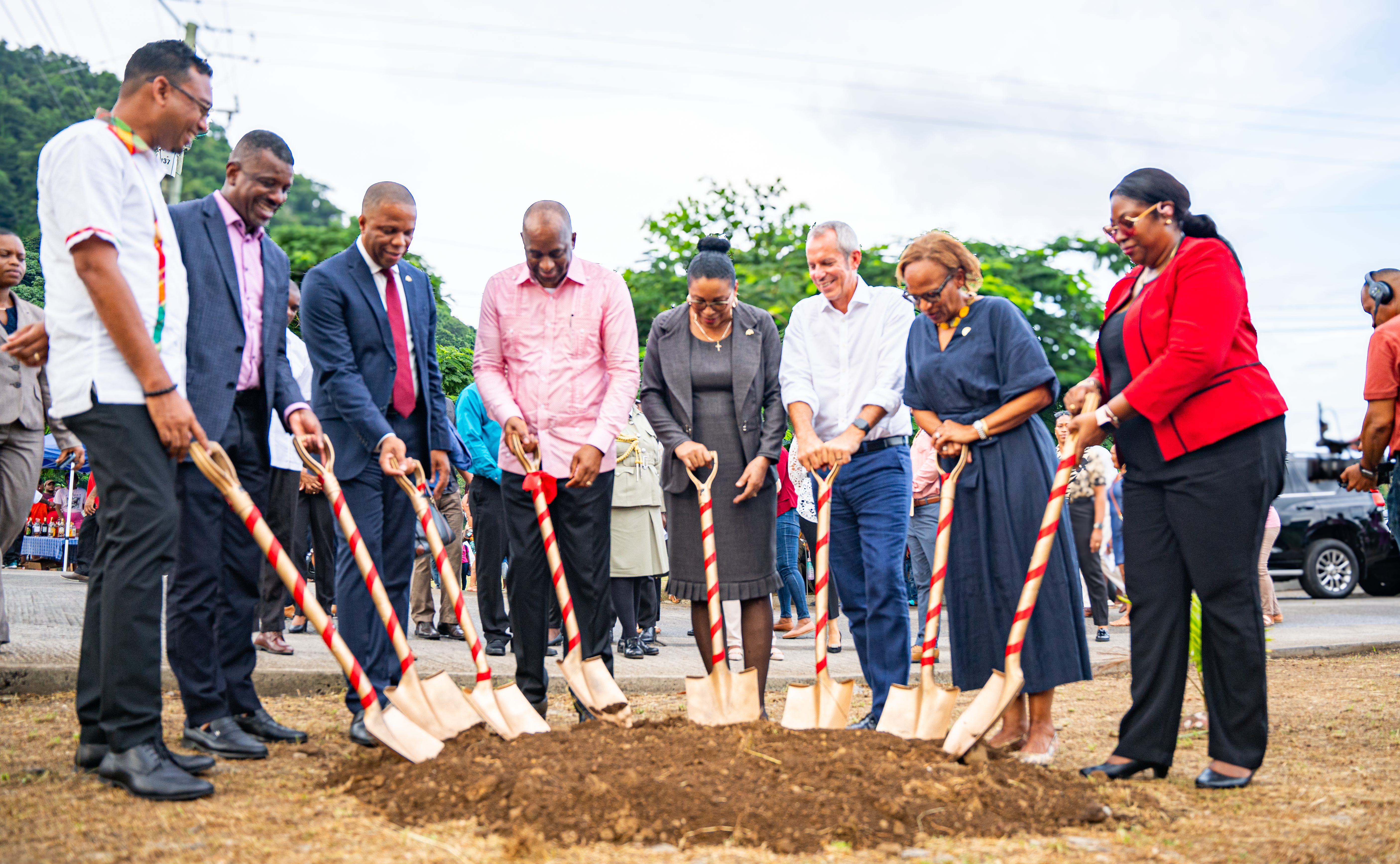 row of people ahead of decorated shovels