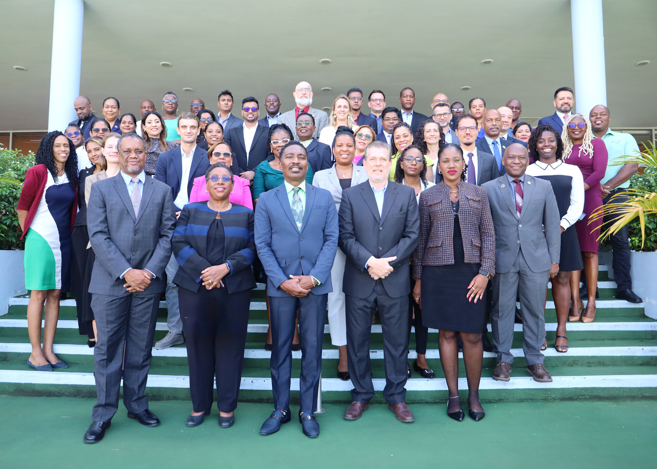 Group photo of workshop participants standing on steps in five rows