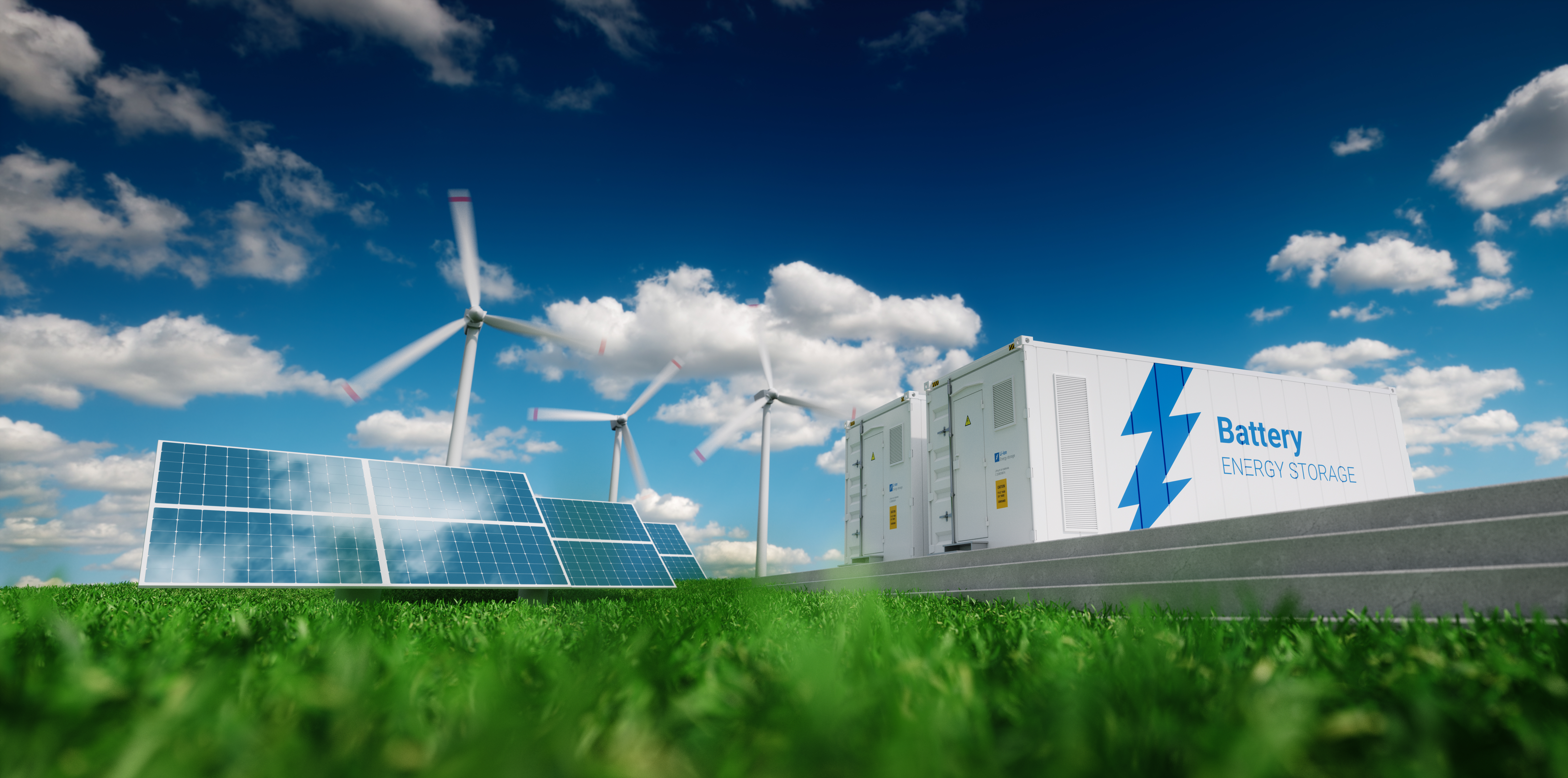 solar panels and wind turbines in foliage against a bright blue sky