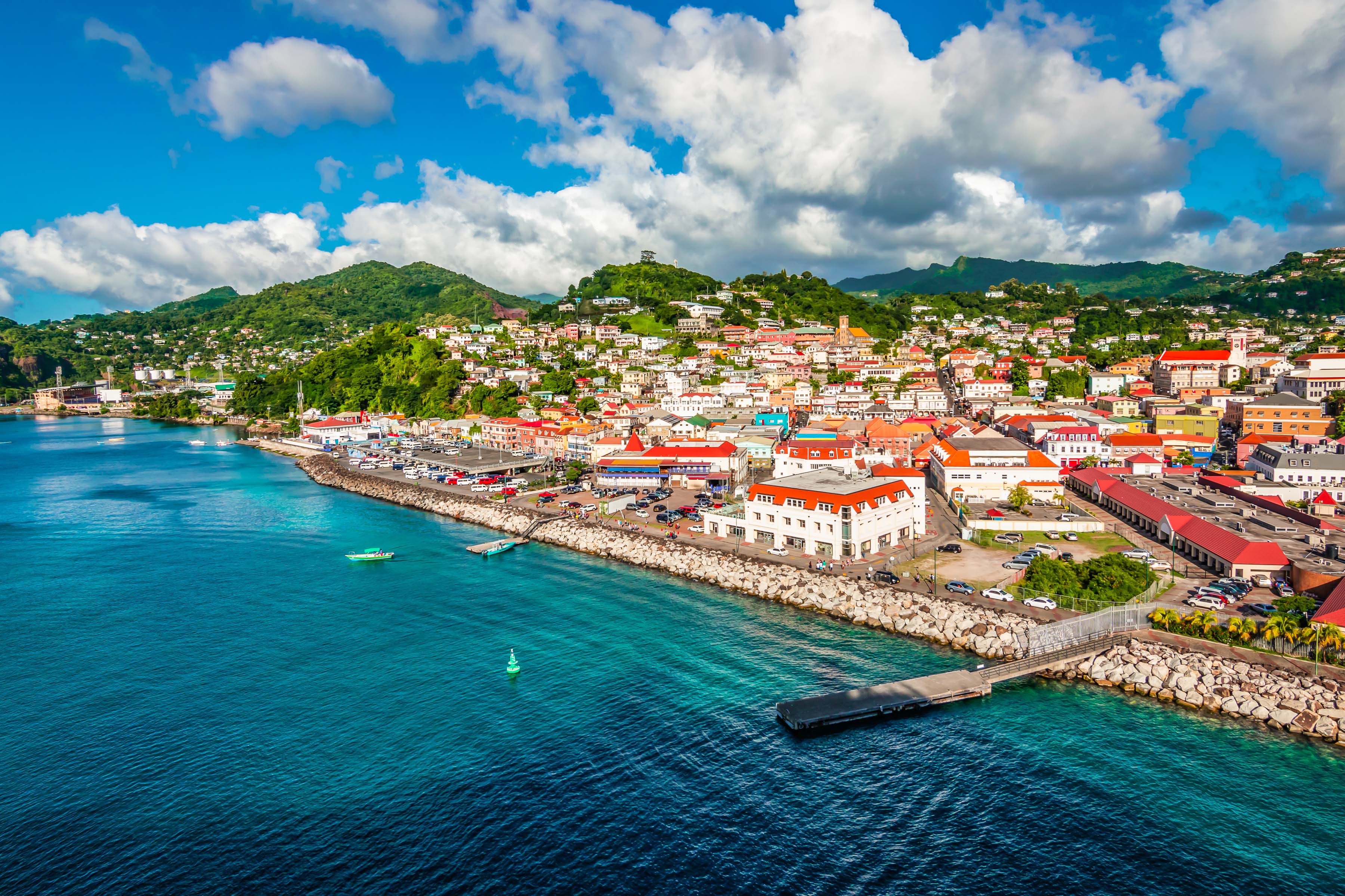 aerial shot of coastal city with expanses of blue sea visible