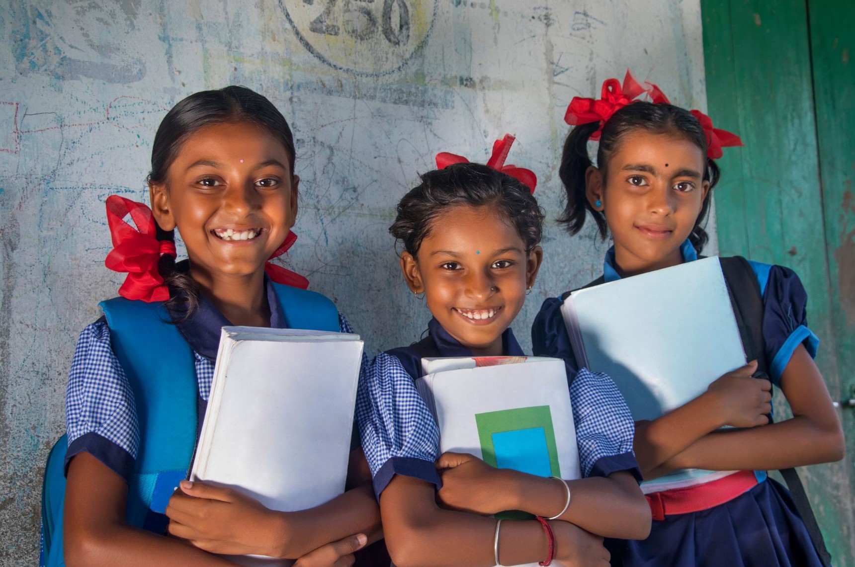 Hindi girls in uniform smiling looking into camera