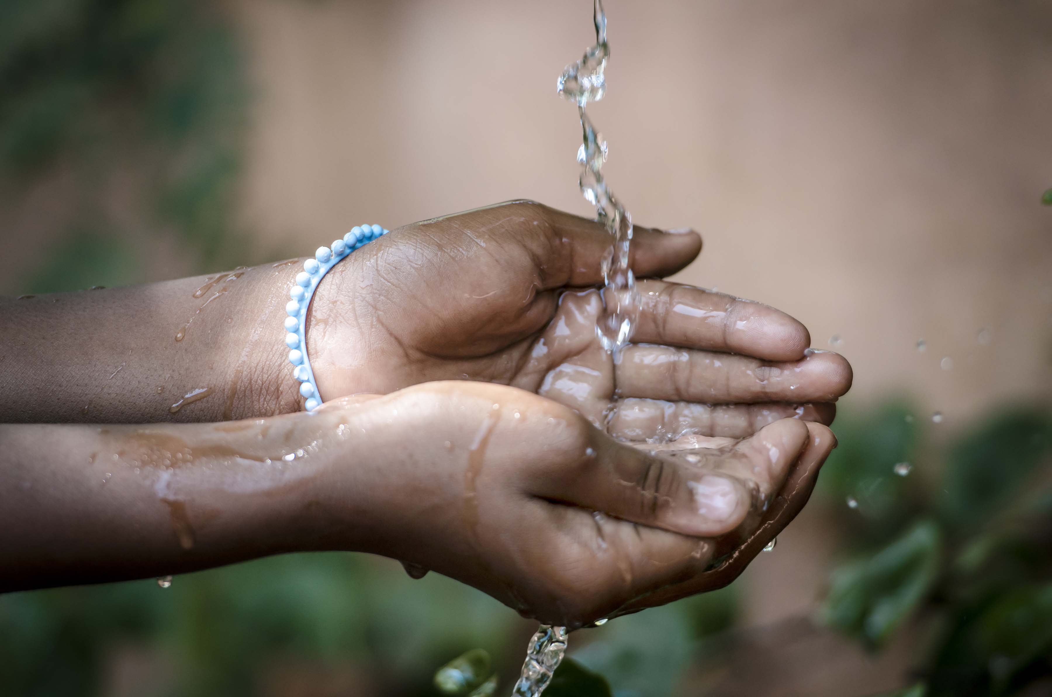 hands cupped to catch water