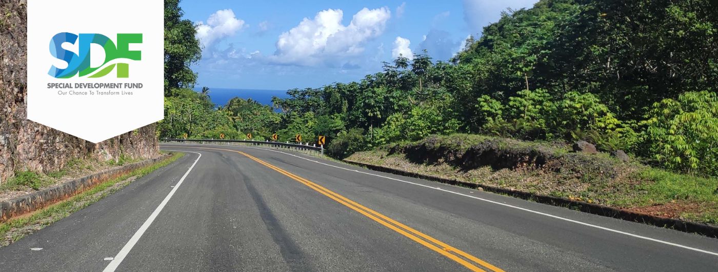 image of paved road disappearing around a corner