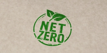 words 'net zero' in green and circled, against brown kraft paper background