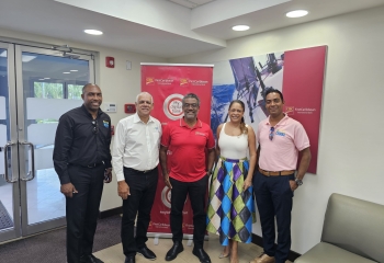 Partnerships are the core of discussions as the BNTF team shares a photo opportunity with Mr. Nigel Ollivierre, Country Head of the CIBC First Caribbean International Bank (centre in red). From left are Brandon Antoine, Deputy Project Manager of the Saint Lucia Social Development Fund, George Yearwood, Portfolio Manager of the BNTF Programme, Samantha Chantrelle, Strategic Partnership Consultant with the BNTF and Edrea Marques, Operations Officer (BNTF).