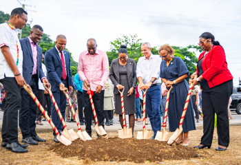 row of people ahead of decorated shovels