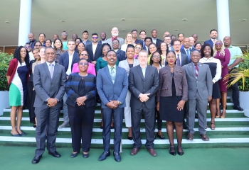 Group photo of workshop participants standing on steps in five rows