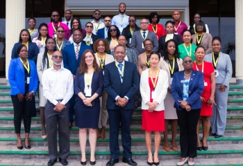 Group of black people in colourful business attire standing in tiered rows 