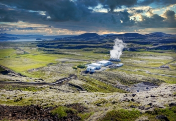Geothermal energy plant in a vast green landscape