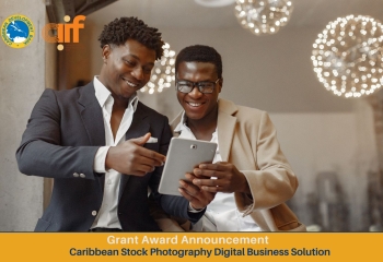 two black men one holding a tablet smiling dressed professionally