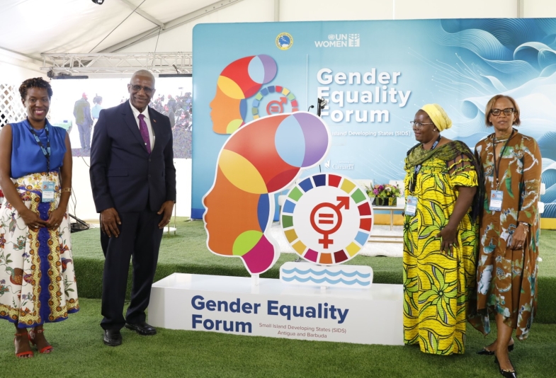 a group of four persons standing in a line flanking the gender equality sign 