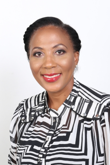 headshot of black woman in a black and white patterned top 